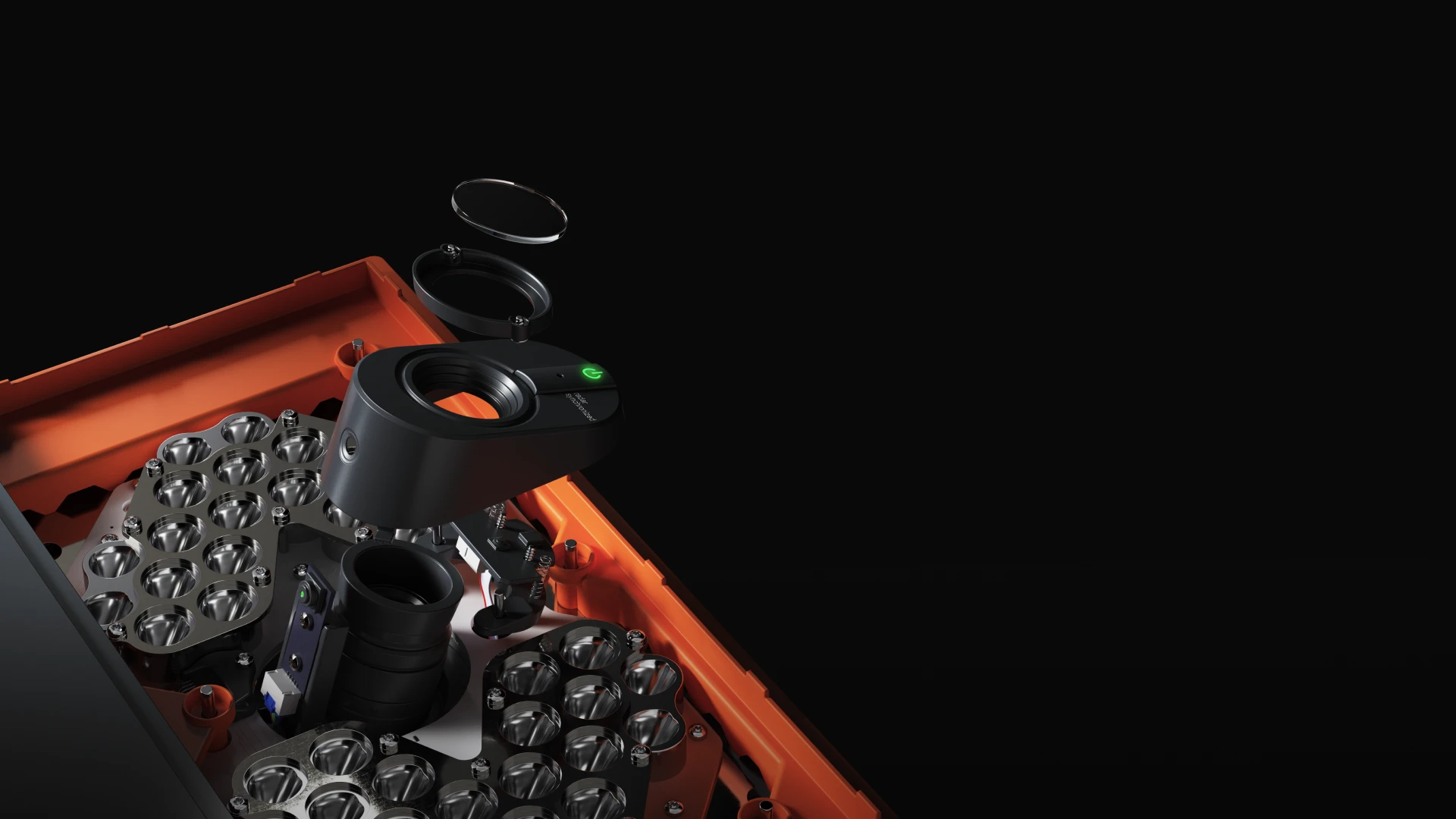 Close-up of a disassembled camera lens with multiple components, including a black lens barrel and orange casing, against a black background.